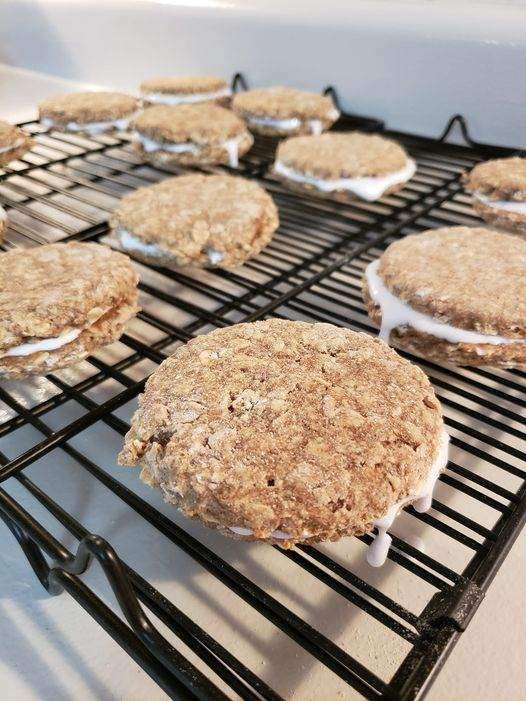 Oatmeal Organic Cream Pie Dog Treats cooling on a rack, soft-baked gluten-free dog cookies with creamy filling.