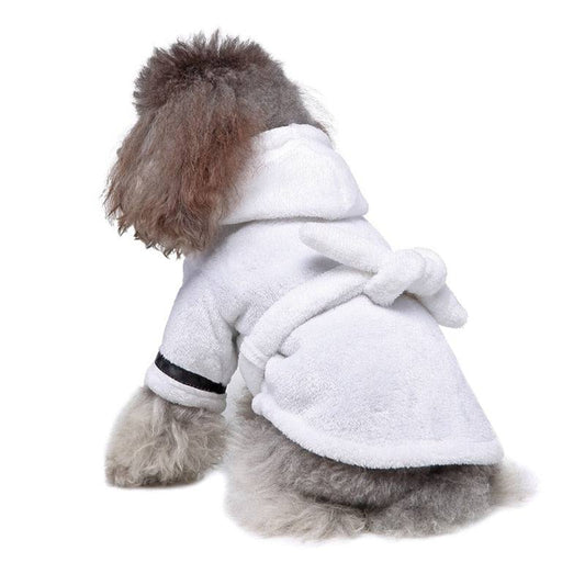 Small dog wearing soft white pet bathrobe pajamas for winter warmth and quick drying
