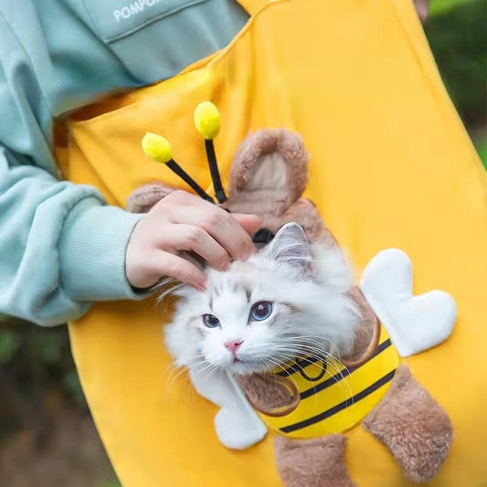 Cute canvas outdoor bag with bee design carrying a white cat outdoors