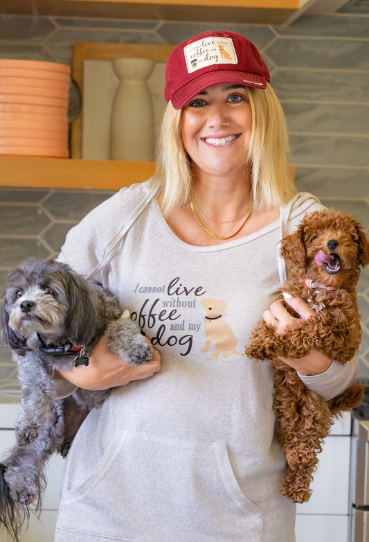 Red-maroon Coffee and My Dog Hat with patch, worn by smiling woman holding two dogs