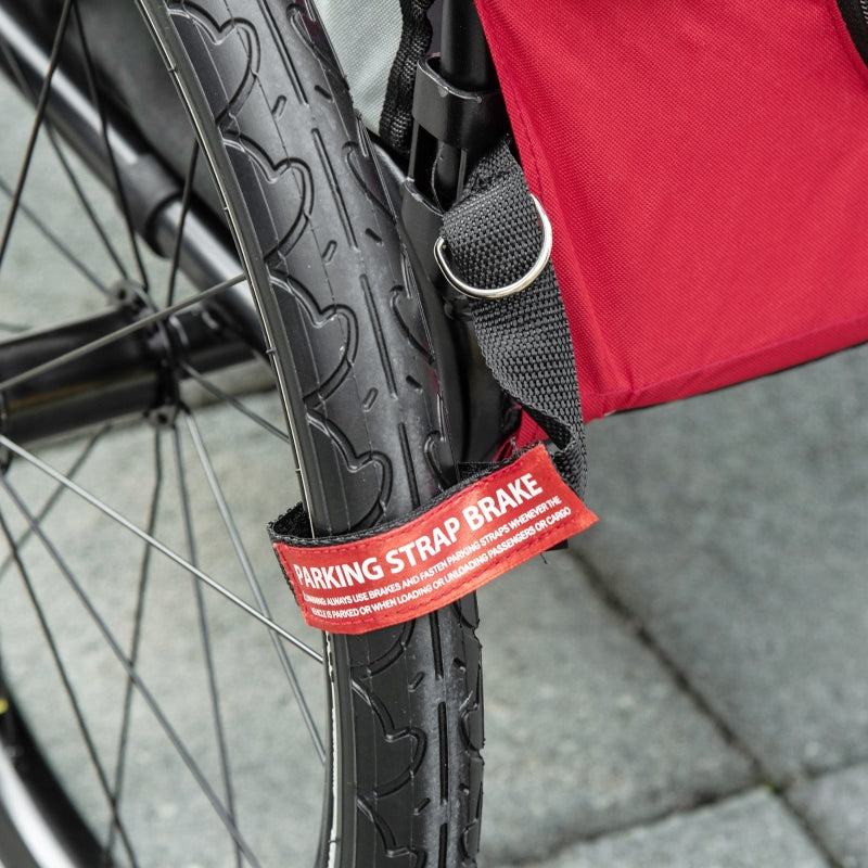 Close-up of parking strap brake on red 2-in-1 pet bike trailer stroller wheel