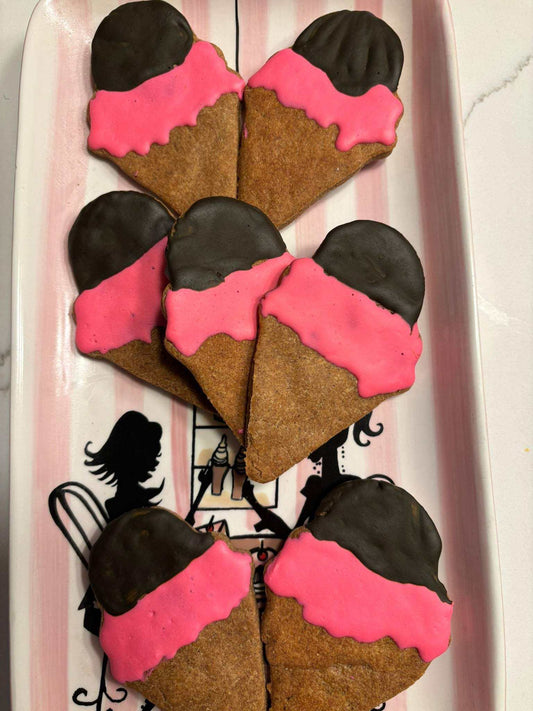 Ice cream organicdog treats with pink and chocolate coating shaped like ice cream cones on a decorative tray
