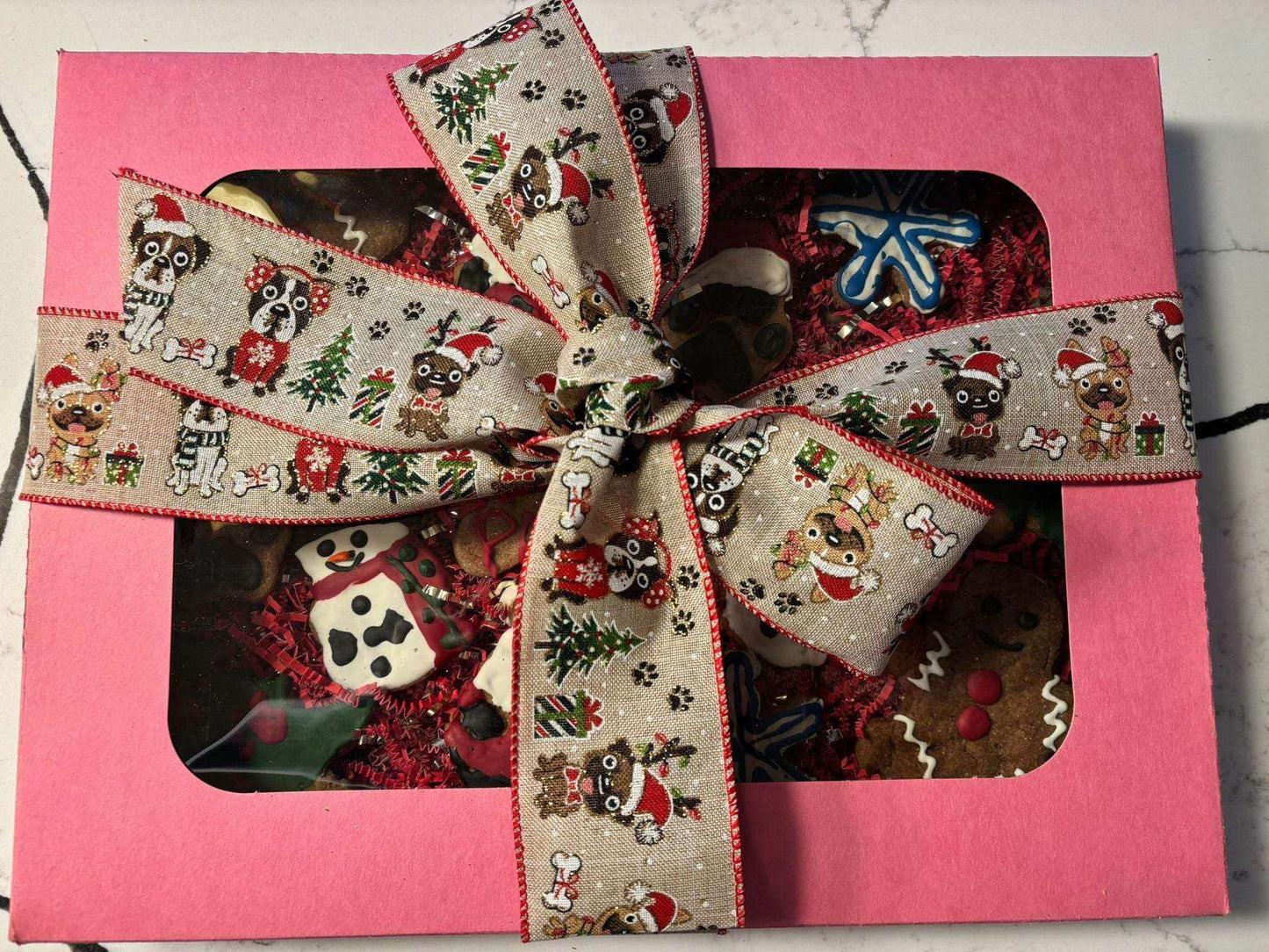 Whimsical organic Christmas dog cookie box with festive peanut butter treats and holiday-themed decorations