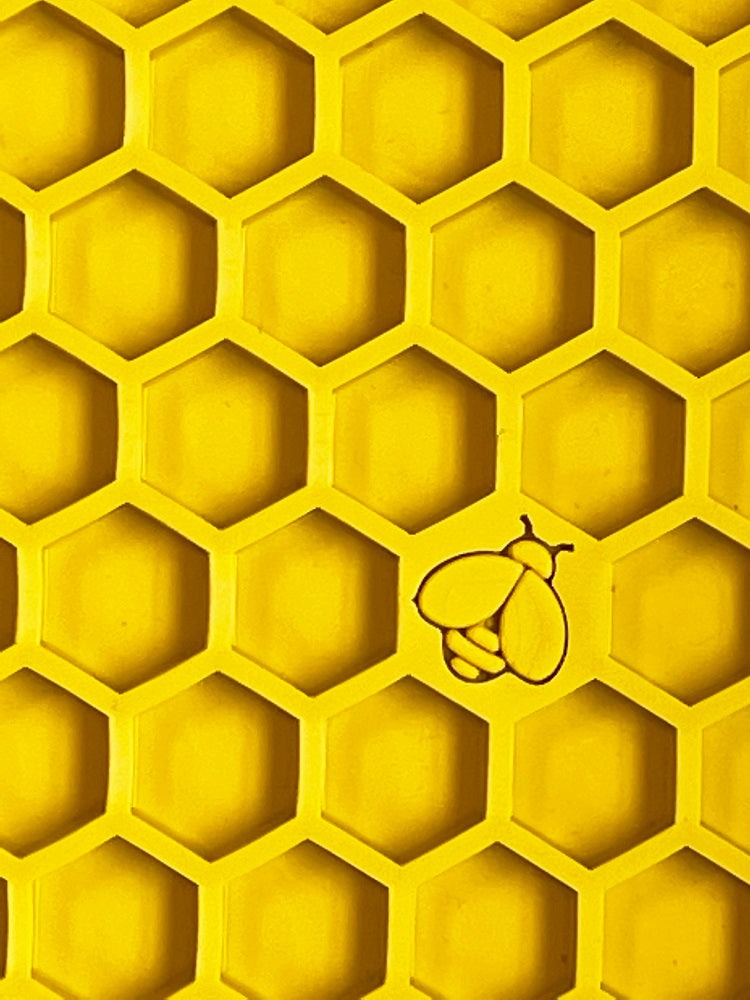 Yellow Honeycomb eMat lick mat for dogs and cats with hexagonal textured cells and bee design for anxiety relief and mental stimulation