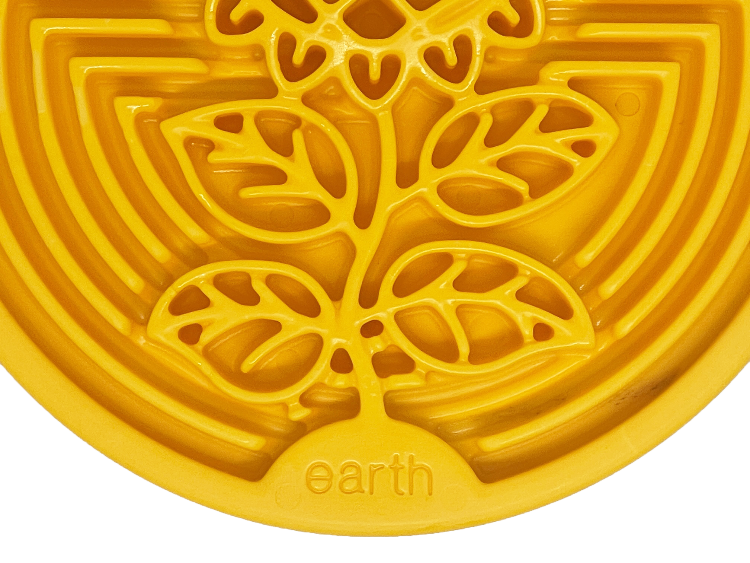 Close-up of yellow Earth eCoin Nylon Lick Mat for dogs with sunflower design and textured surface for enrichment and anxiety relief