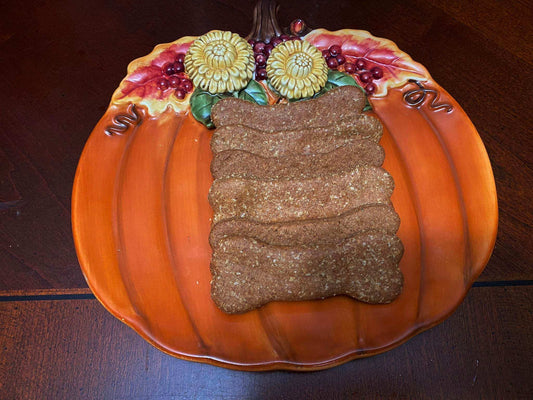 Peanut Butter Organic Bones for dogs stacked on a decorative pumpkin plate