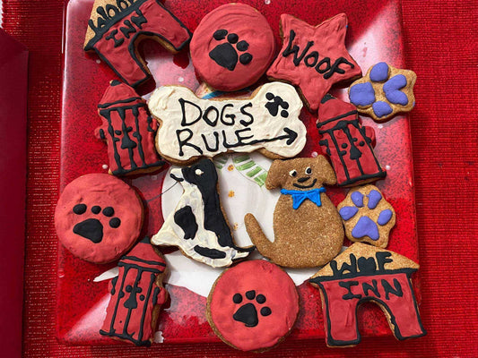 Assorted organic dog cookies with paw prints, dog shapes, and "Dogs Rule" bone cookie from Dog Life Organic Dog Cookie Box