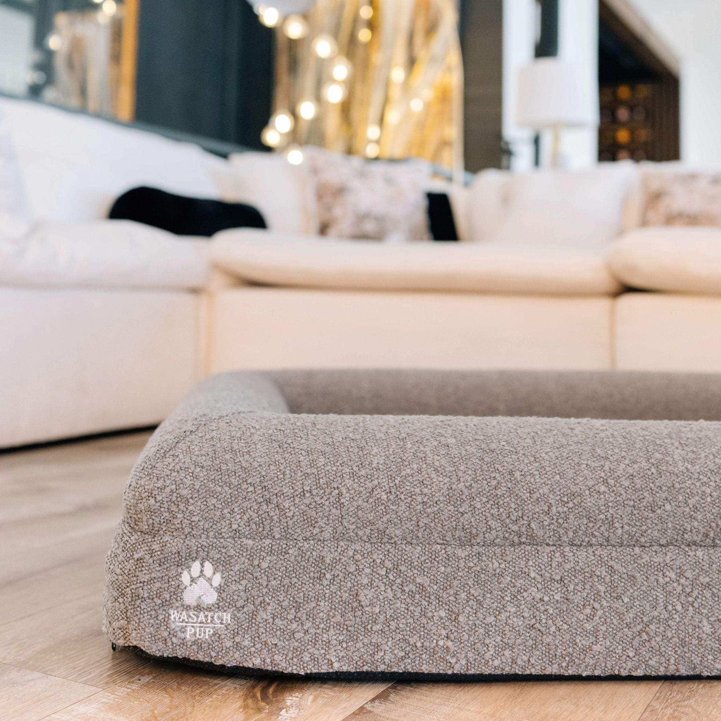 Luxury orthopedic dog bed with memory foam, plush boucle cover, and raised bolsters for comfort.