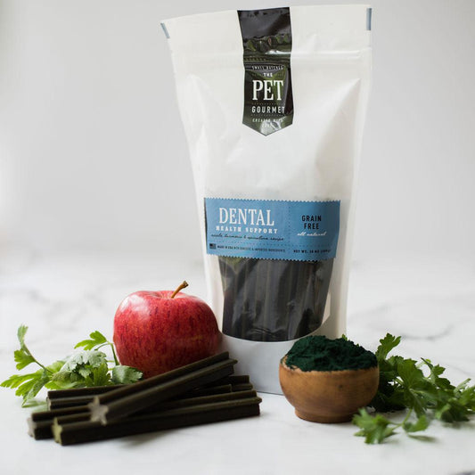 Package of grain-free Dental Support Chews for dogs with star-shaped sticks, apple, parsley, and spirulina ingredients displayed.