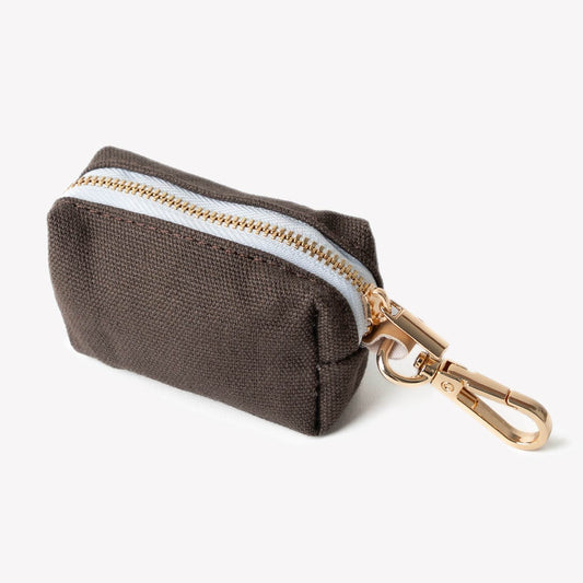 brown poop bag holder clipped to leash with poop bag roll inside