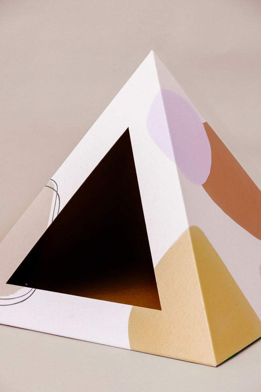 Abstract cardboard cat pyramid with modern artistic design and cozy hideaway for cats
