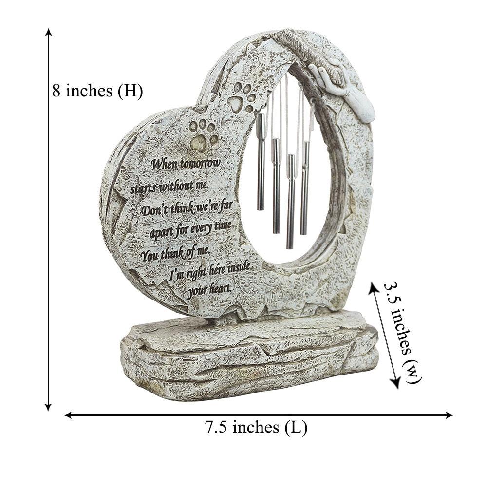 Heart-shaped pet memorial stone with paw prints and wind chimes for outdoor garden remembrance