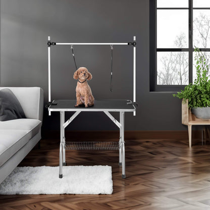 36-inch adjustable portable black dog pet grooming table with stainless steel legs, arm, noose, and mesh tray in modern room