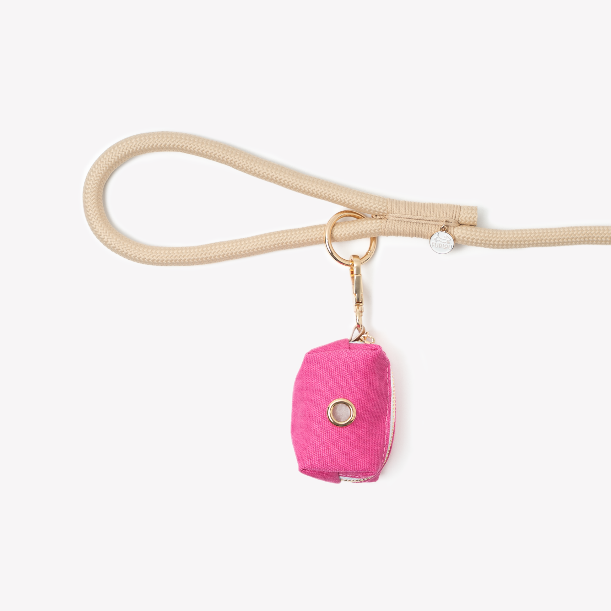 Magenta poop bag holder attached to beige leash clip for convenient dog waste cleanup