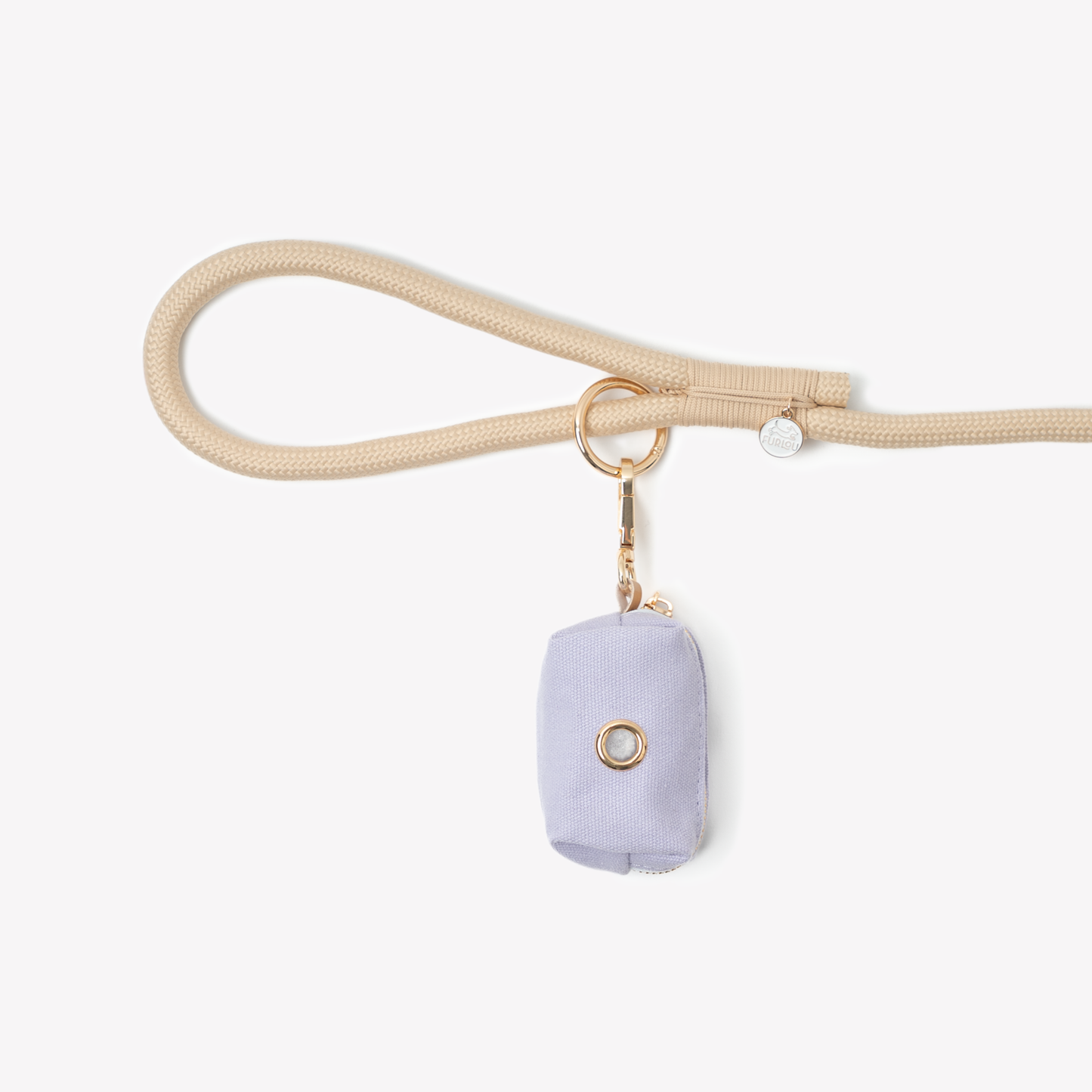 Lavender poop bag holder clipped to beige dog leash with gold hardware