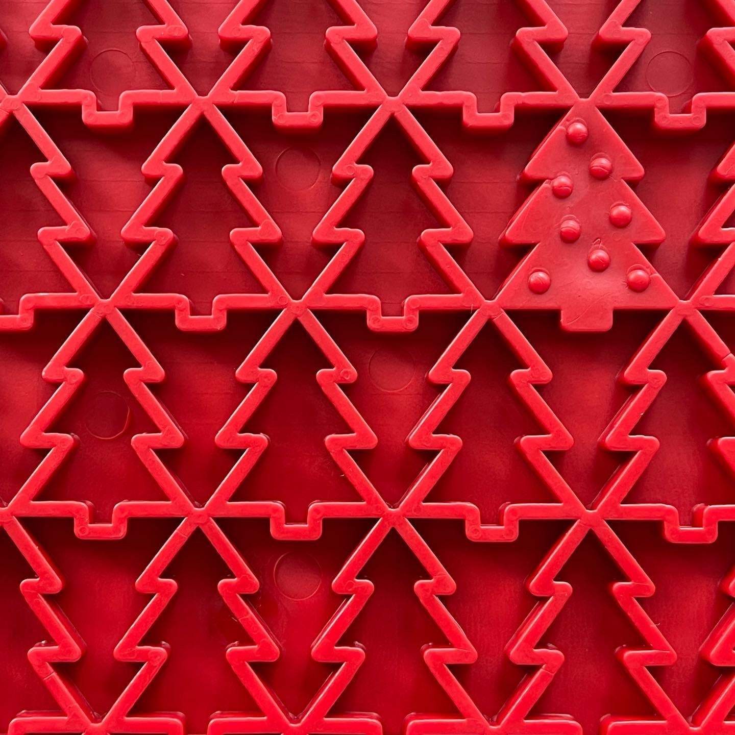Close-up of red Peace Tree emat dog lick mat with textured Christmas tree design for anxiety relief and enrichment