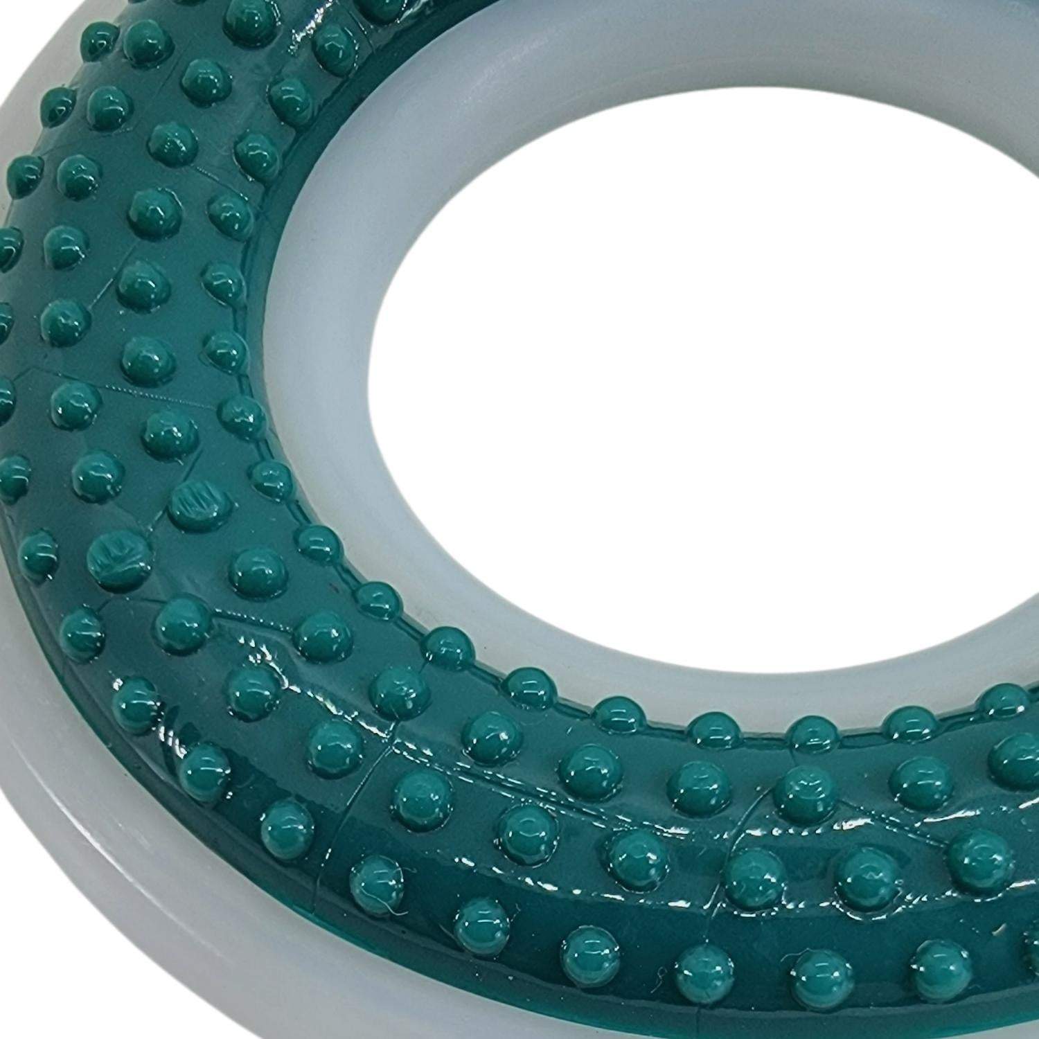 Close-up of green and white TPR and Nylon dental chew ring toy for dogs with textured surface for plaque removal and gum stimulation
