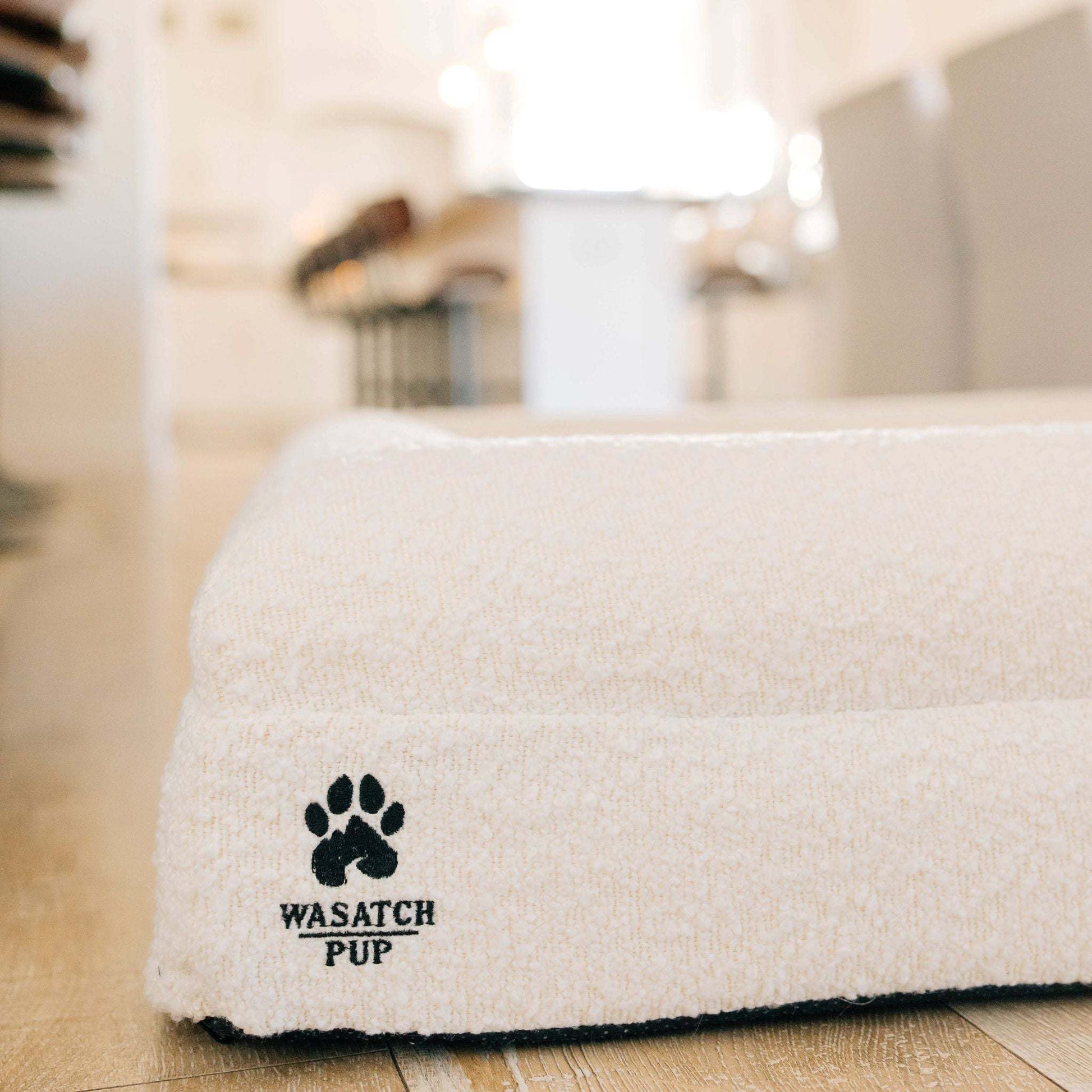 Luxury orthopedic dog bed with memory foam, plush boucle cover, and raised bolsters for comfort and support