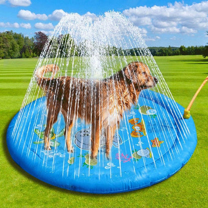 Dog playing on blue inflatable pet sprinkler pad with water spray outdoors on grass