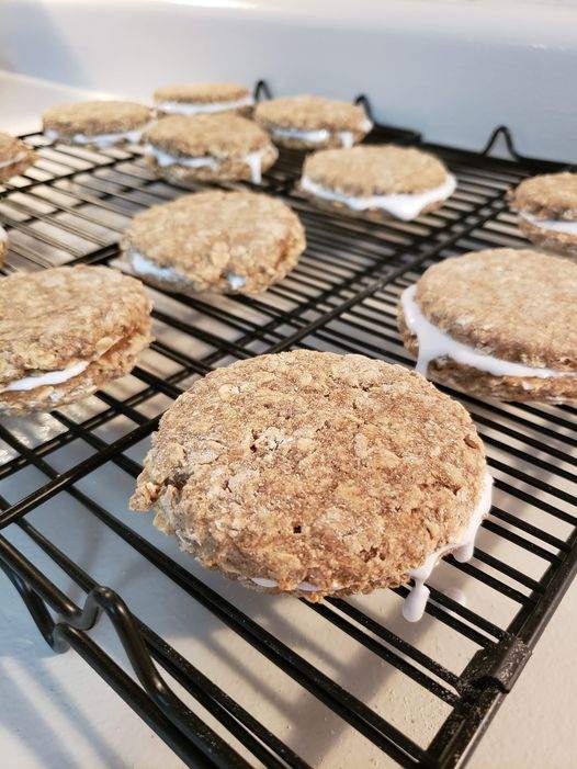 Oatmeal Organic Cream Pie Dog Treats cooling on a rack, soft-baked gluten-free dog cookies with creamy filling.