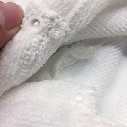 Close-up of white soft cotton pet bath robe with hood and snap button closure