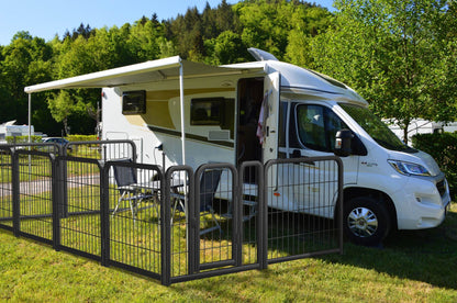 Portable 8-panel black iron dog fence 24-inch tall enclosure around RV on grass