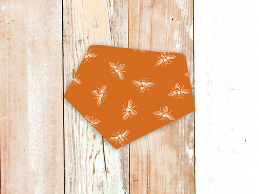 Orange Bees Dog Bandana with white bee pattern and adjustable snap closures on orange fabric.
