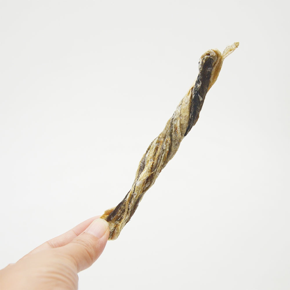 Jack PetPals Seafood Feast codfish skin treat chew held in hand, natural grain-free dog snack rich in Omega-3