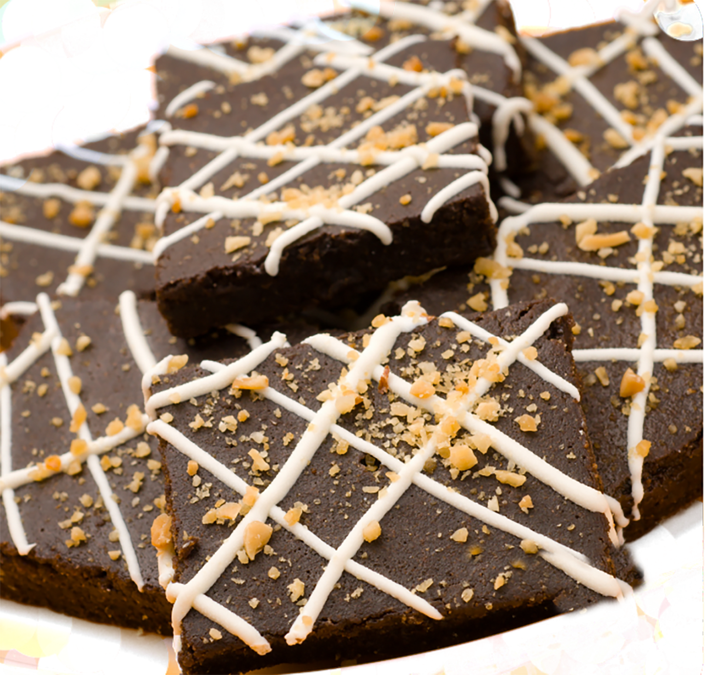 Brownie organic dog treats with white drizzle and nut topping, soft and chewy pet snacks made from all-natural ingredients.