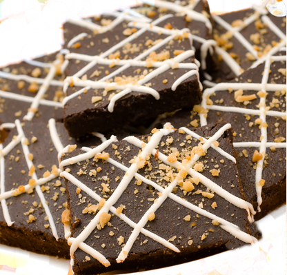 Brownie organic dog treats with white drizzle and nut topping, soft and chewy pet snacks made from all-natural ingredients.
