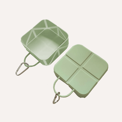 Compact foldable pet food and water bowl in green with carabiner for travel use