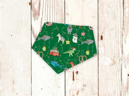 Adjustable green dog bandana with festive fun ornaments pattern and snap closures
