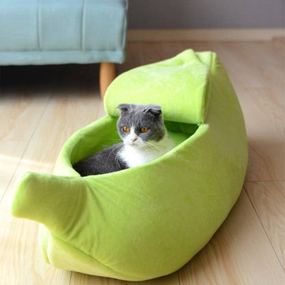 Green banana-shaped pet bed with cat inside, cozy plush fabric, foldable and portable design