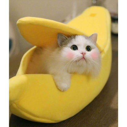 Cute cat resting inside a yellow banana pet bed with peelable cover, soft plush fabric and cozy design