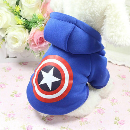 Small dog wearing blue cartoon hoodie sweater with Captain America shield design