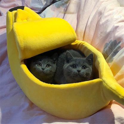 Yellow banana-shaped pet bed with two gray kittens inside cozy plush fabric pet house