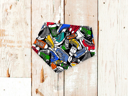 Colorful sneaker print High Tops dog bandana with adjustable snap closures on wooden background