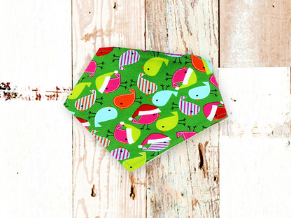 Holiday Birds Dog Bandana with colorful bird pattern on green cotton fabric and adjustable snap closures