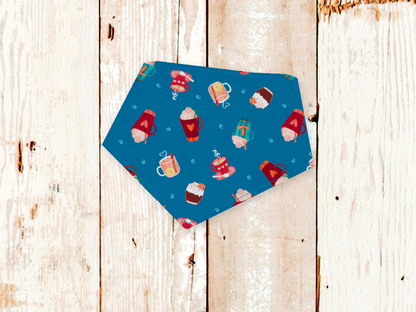 Blue Hot Cocoa Dog Bandana with adjustable snaps and flannel backing on wooden surface