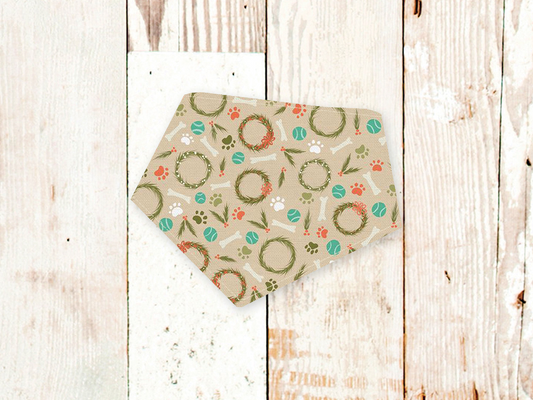Adjustable Howlidays dog bandana with festive wreath and paw print design, cotton flannel backed, machine washable