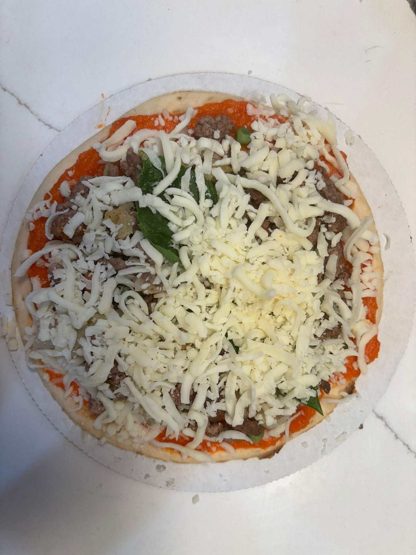 Finn's Pizza dog treat with organic beef, vegetables, basil, mozzarella cheese on a chewy crust