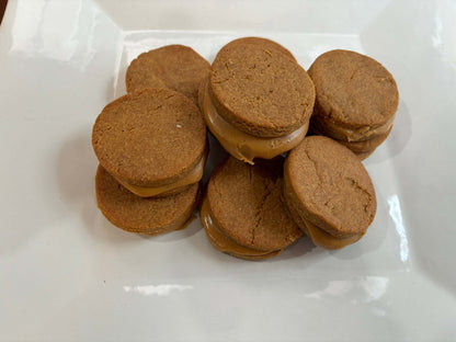 Organic peanut butter macarons dog treats stacked on white plate