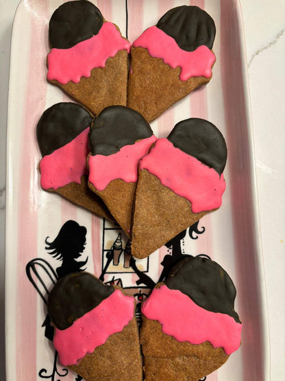 Ice cream organicdog treats with pink and chocolate coating shaped like ice cream cones on a decorative tray