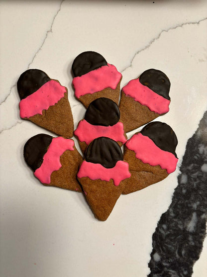 Ice cream organic dog treats shaped like ice cream cones with pink and chocolate icing