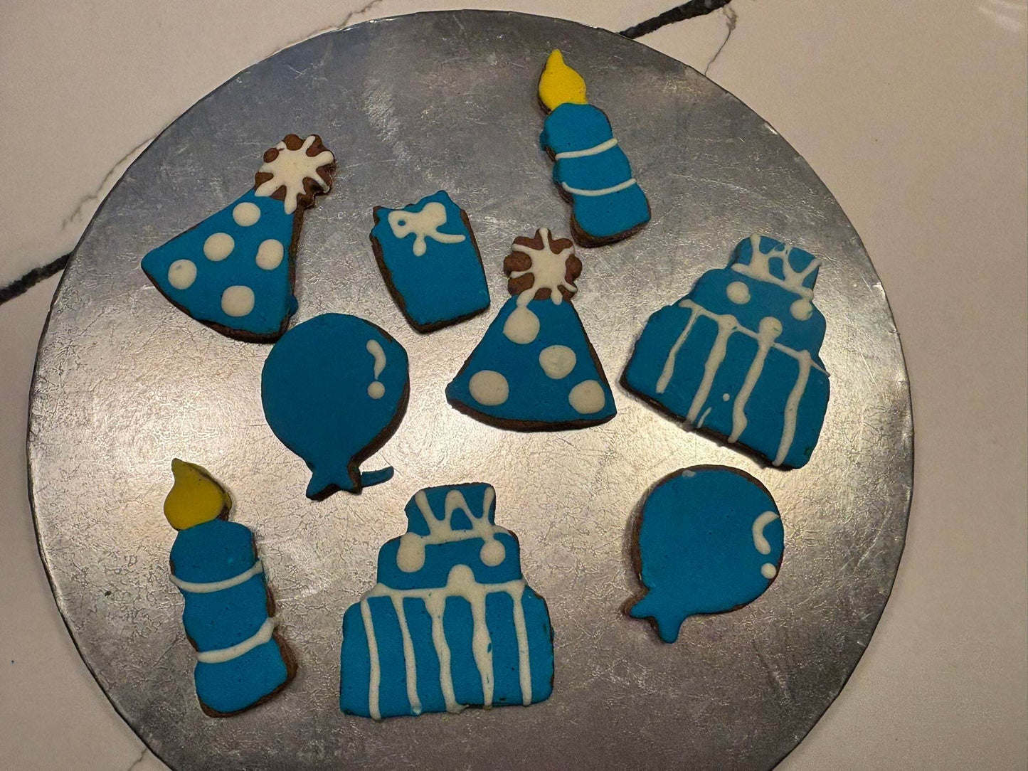 Birthday Boy Organic Dog Cookie Box with blue birthday-themed peanut butter cookies including cakes, candles, balloons, and party hats