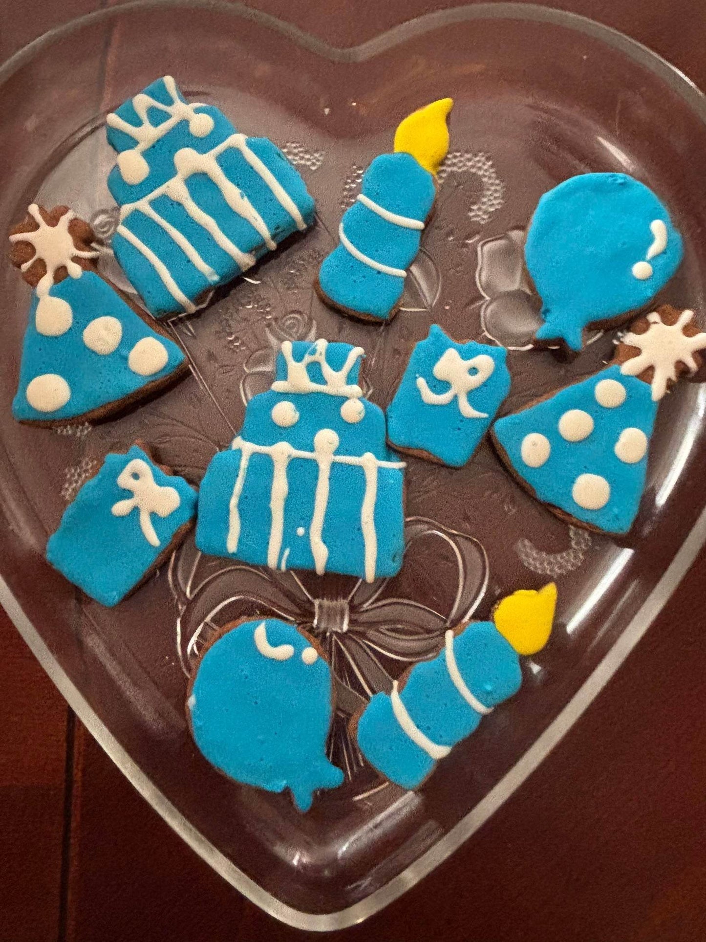 Birthday Boy Organic Dog Cookie Box with blue and white festive shaped peanut butter cookies on a heart-shaped plate
