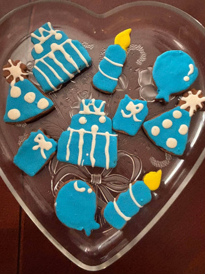 Birthday Boy Organic Dog Cookie Box with blue and white festive shaped peanut butter cookies on a heart-shaped plate