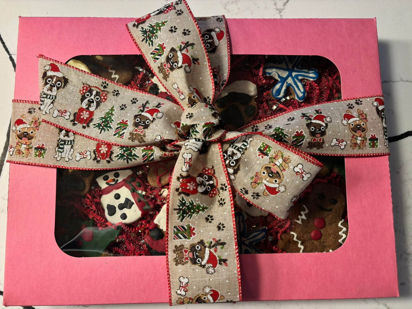 Whimsical Organic Christmas dog cookie gift box with festive holiday-themed treats and decorative ribbon