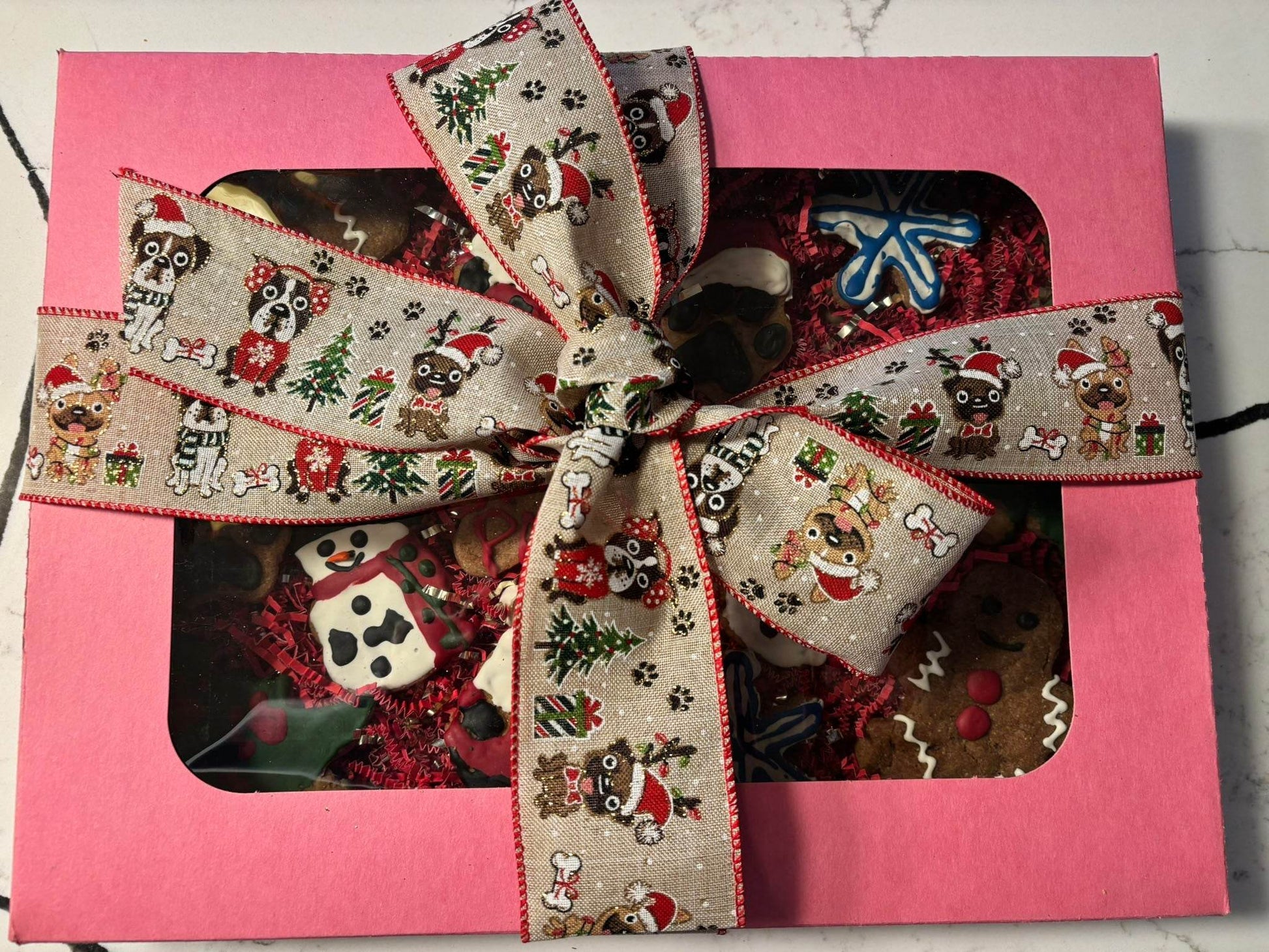 Whimsical Organic Christmas dog cookie gift box with festive holiday-themed treats and decorative ribbon
