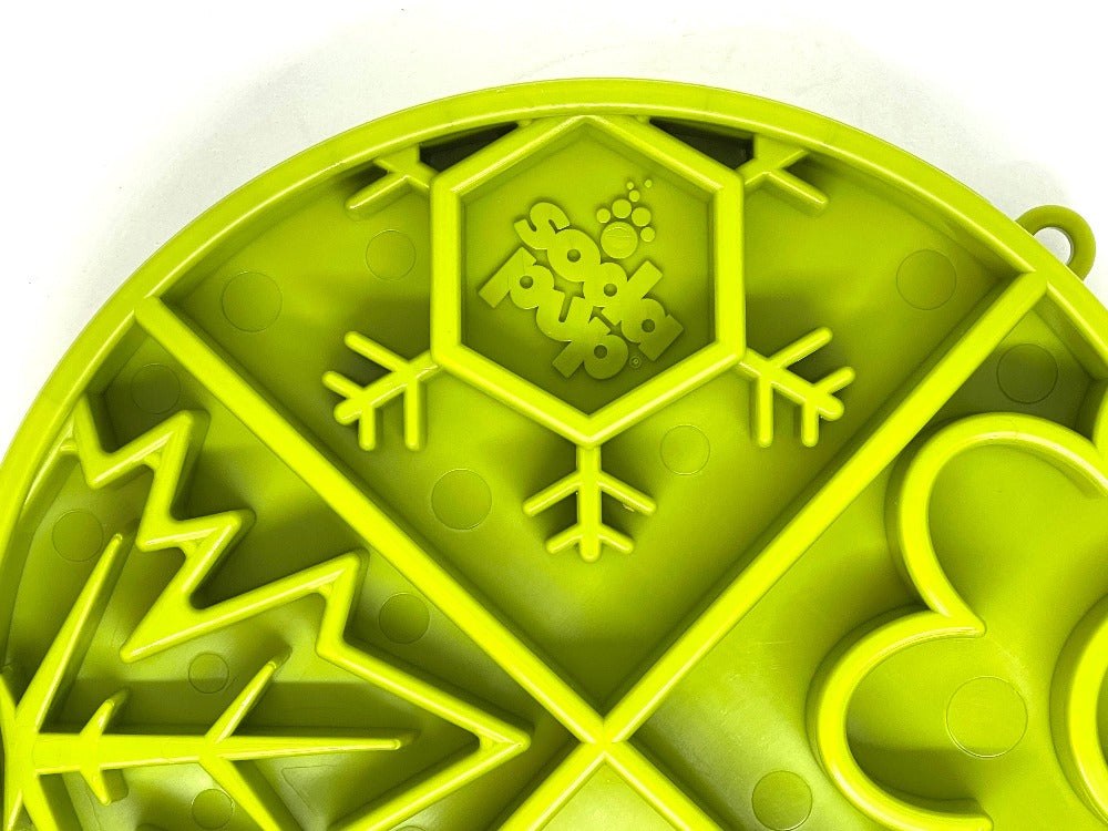 Close-up of green Four Seasons Design eTray shallow slow feeder dog bowl with raised ridges and seasonal patterns for enrichment